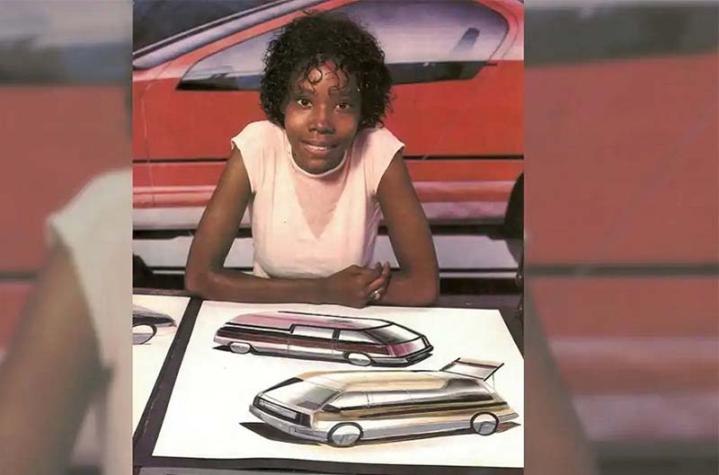 Emeline sitting in front of her designs